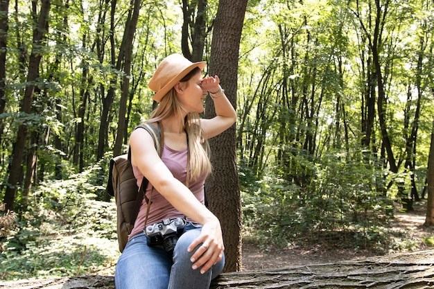 Woman in the woods looking away