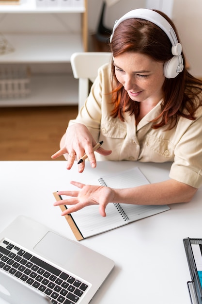 Woman at work having video call on laptop