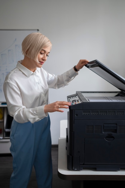 Free Photo woman at work in the office using printer