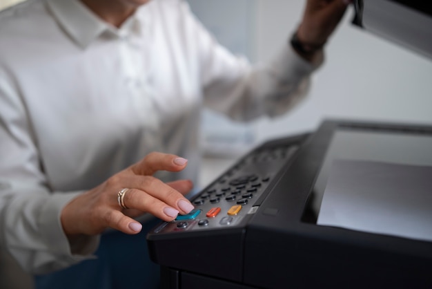 Woman at work in the office using printer