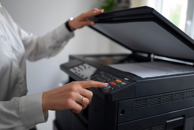 Woman at work in the office using printer