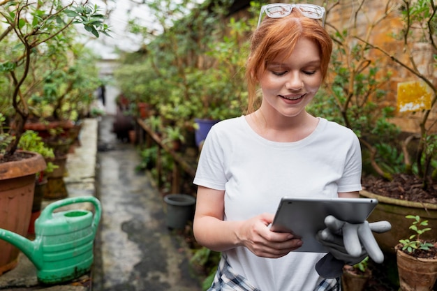 Free photo woman working hard in a greenhouse