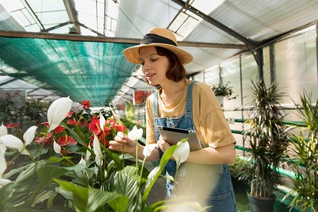 Woman working in her sustainable greenhouse