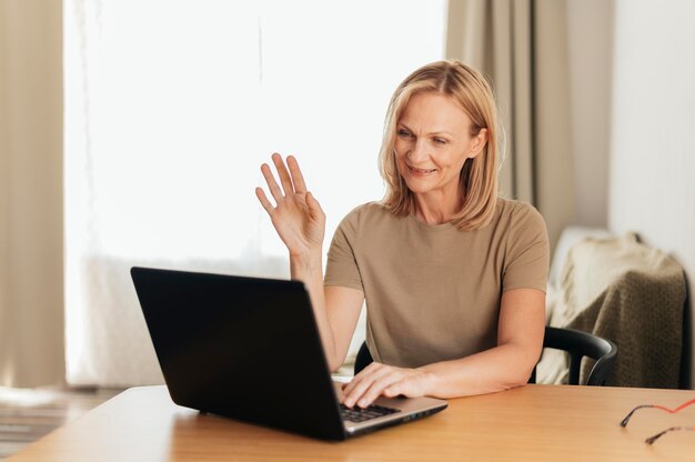 Woman working at home during quarantine with laptop