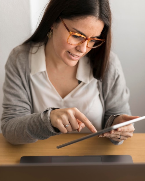 Woman working at home on tablet