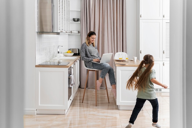 Woman working at home with kid