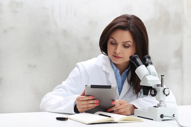 Woman working in the lab with a microscope