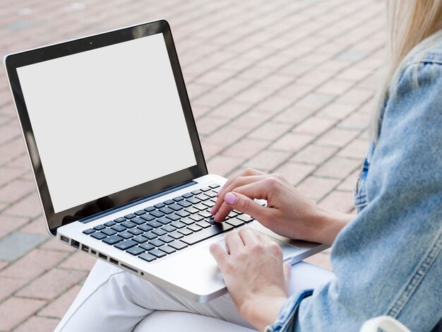 Woman working on laptop outside