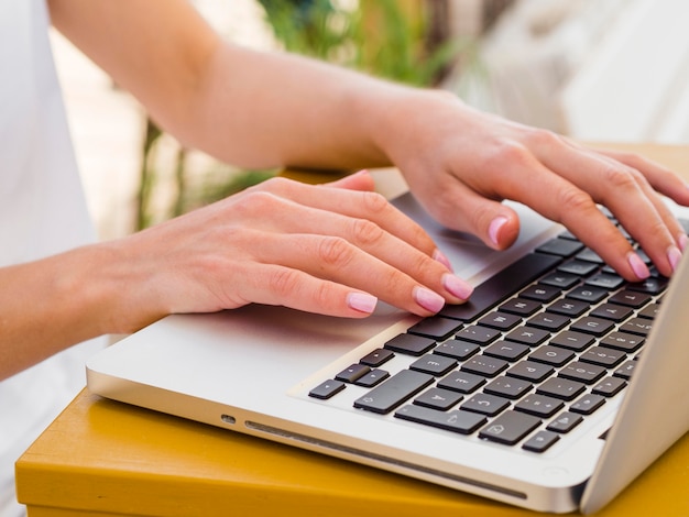 Free photo woman working on laptop outside