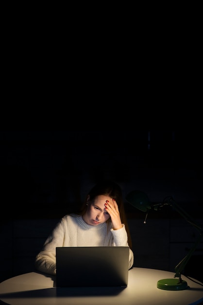 Free photo woman working on laptop with copy space