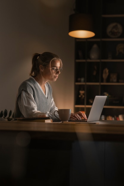 Woman working late at night side view