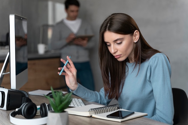 Woman working in the media field with personal computer and smartphone