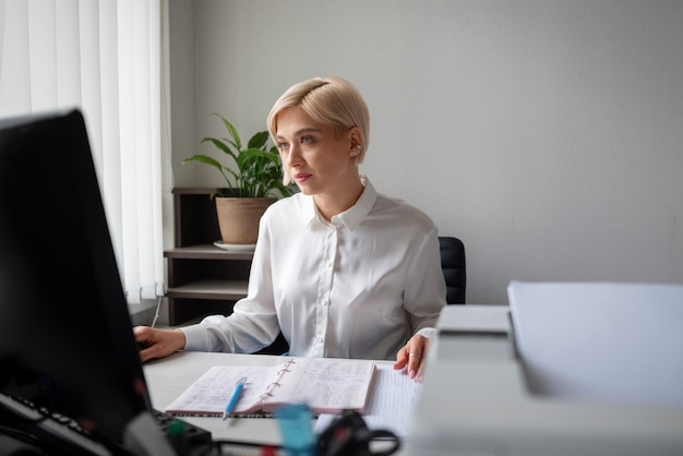 Free photo woman working in the office and using printer