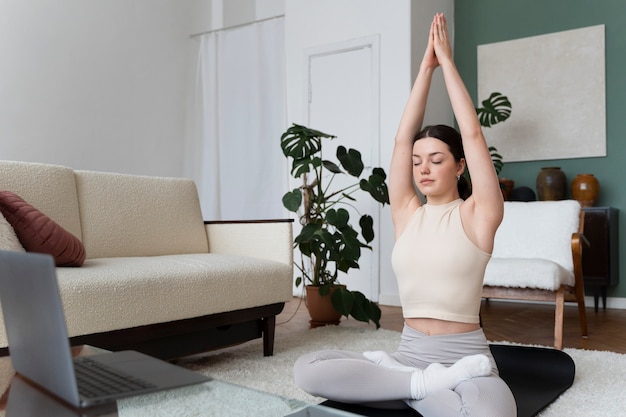 Woman working out after online fitness instructor