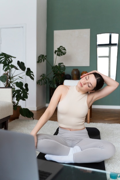 Woman working out after online fitness instructor