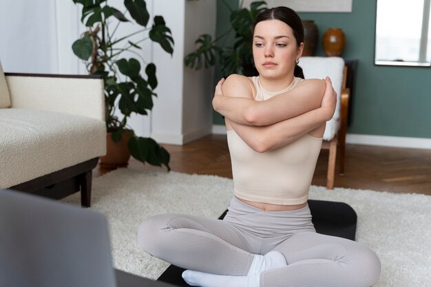 Woman working out after online fitness instructor