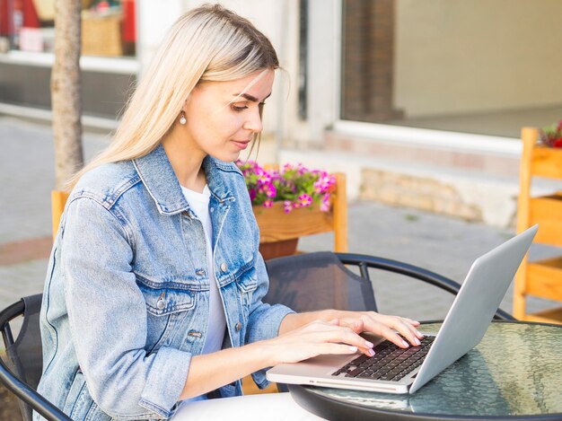 Woman working outdoors on laptop