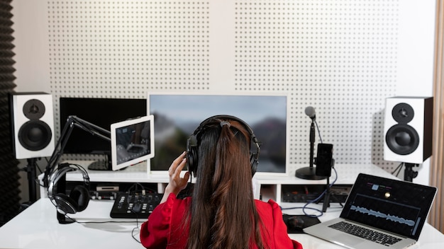 Woman working at a radio station with special equipment