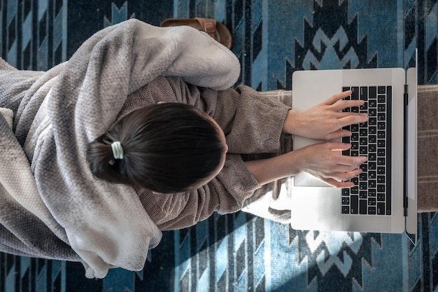 Free photo a woman working sitting at a laptop top view