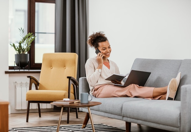 Free Photo woman working while sitting on the sofa