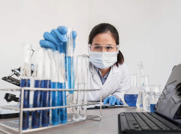 Free photo woman working with chemical substances in lab