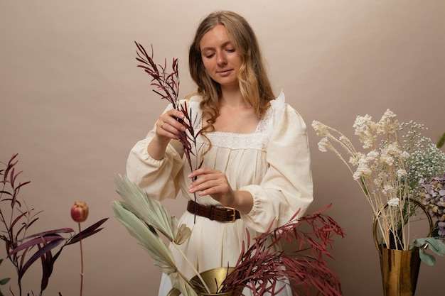 Woman working with dried plants front view