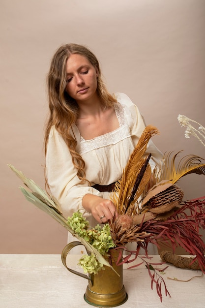 Woman working with dried plants medium shot