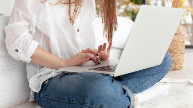 Woman working with her laptop on her lap