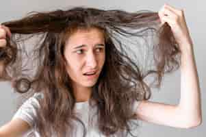 Free photo woman worried about tangled hair