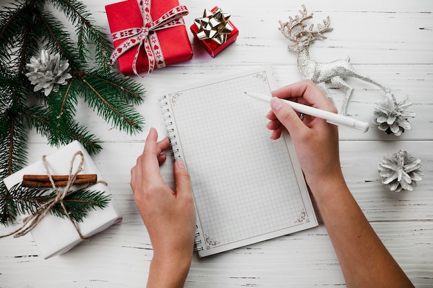 Woman writing on blank sheet of paper with pen