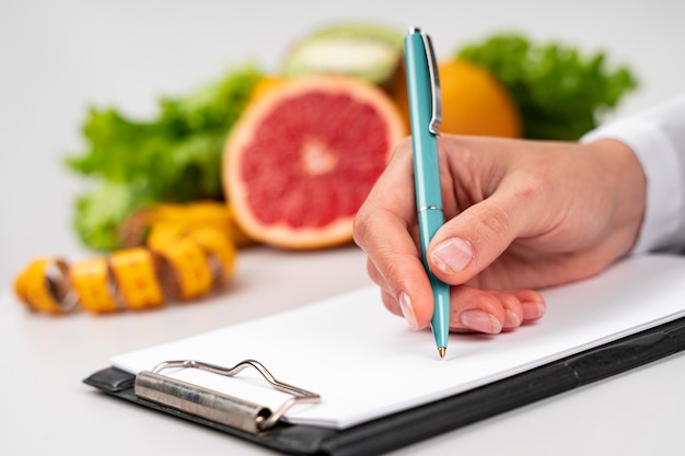 Woman writing and blurred fruit