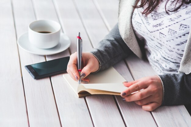 Woman writing in a diary