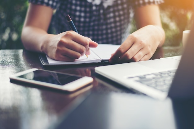 Woman writing on a notebook