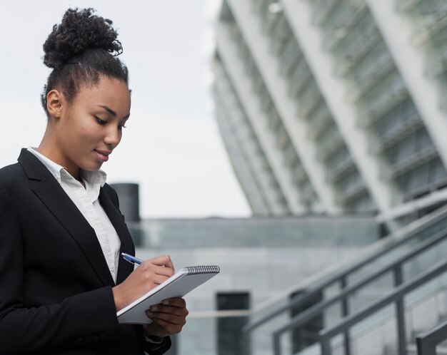 Woman writing in notepad