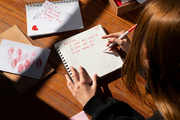 Free Photo woman writing a romantic love letter to someone