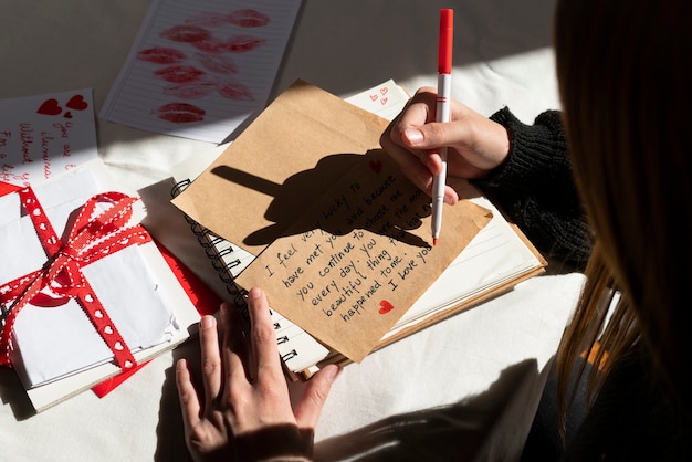 Free photo woman writing a romantic love letter to someone