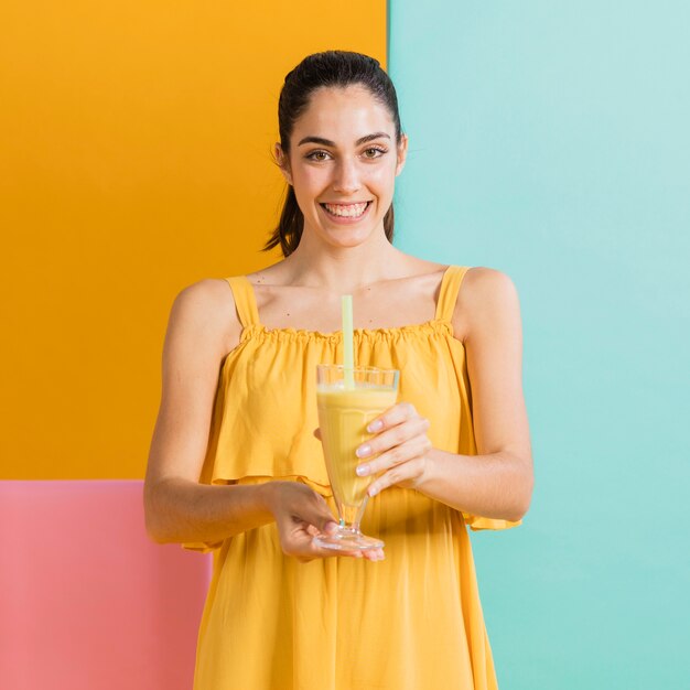 Woman in yellow dress with a glass of juice