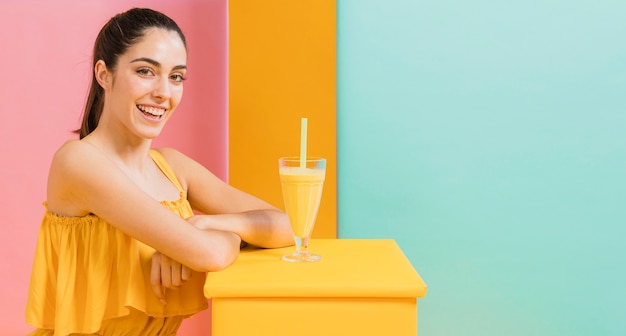 Woman in yellow dress with a glass of juice