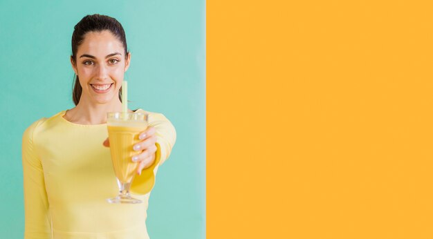 Free Photo woman in yellow dress with juice