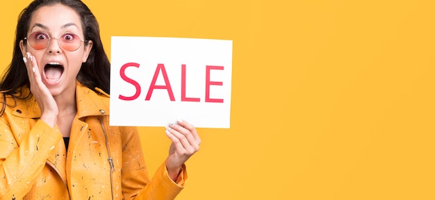 Free photo woman in yellow jacket copy space sale concept