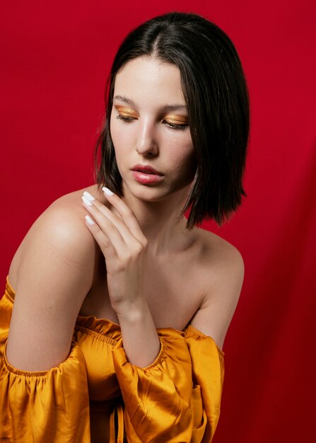 Woman in yellow top posing soft