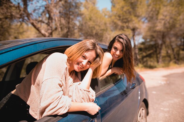 Women in car looking at camera