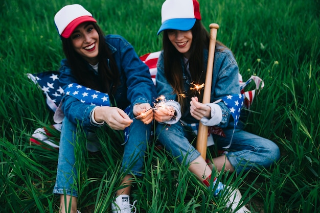 Free Photo women in colored caps celebrating 4th of july