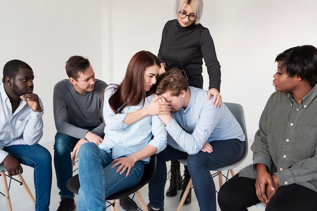 Free photo women consoling male rehab patient