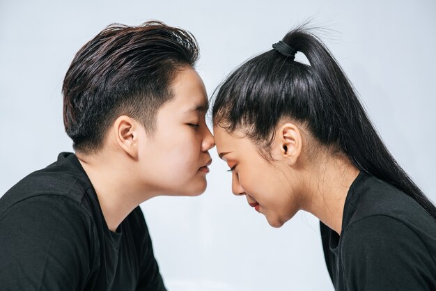 Women couples stand and fragrant cheek.