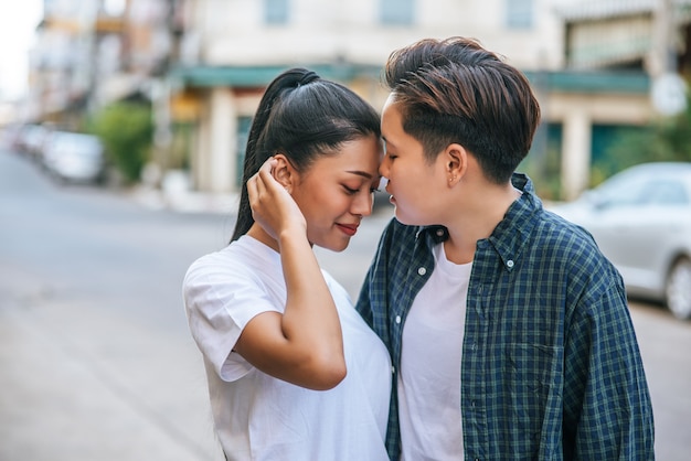 Women couples stand and fragrant cheek.