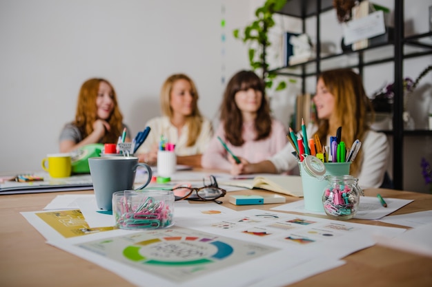 Free photo women at desk with supplies