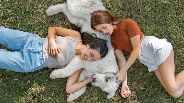 Free photo women and dog sitting on grass