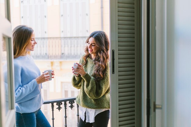 Women drinking on balcony