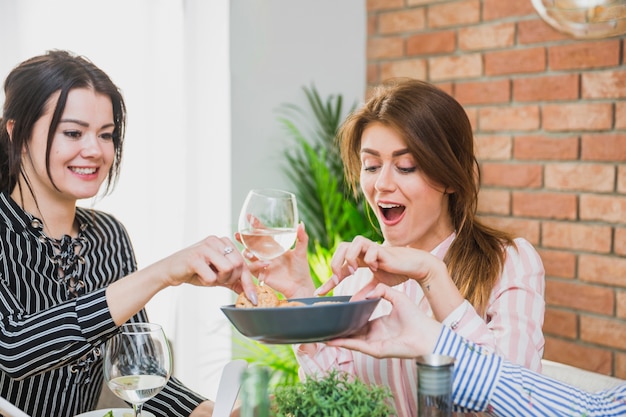 Free photo women drinking wine and eating sweets